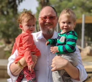 Dave Felsenthal - the Rabbi who got rich on Sunday - holding grandbabies